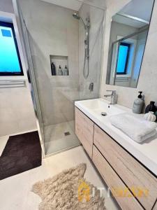LyonsLavish in Lyons - 3bd 2bth Spacious & Modern Home的带淋浴、盥洗盆和镜子的浴室