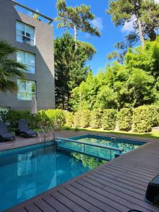 卡里罗Suite House Carilo的后院的游泳池,设有木甲板