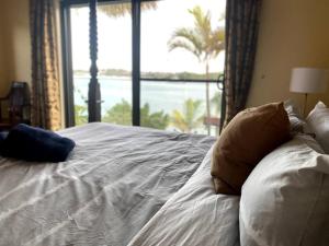悉尼Private Beach Villa on Water's Edge的一间卧室设有一张大床和大窗户