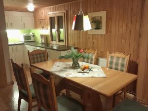 锡贝塔尔Haus Silke的厨房配有木桌、桌椅、桌子和桌子。