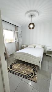 杰尔吉斯Residance saji的白色的卧室设有床和窗户