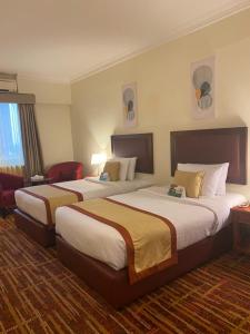 阿布扎比阿尔迪阿米娜酒店的一间酒店客房,房间内设有两张床