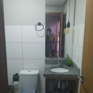 路易斯科雷亚Condomínio Villamares的一个带水槽的浴室和一个在镜子里拍照的人