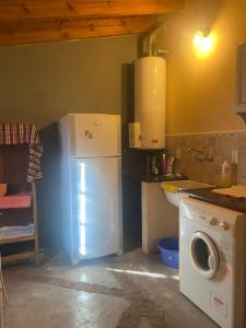 卡尔韦Casitas El Lago的厨房配有冰箱和洗衣机。