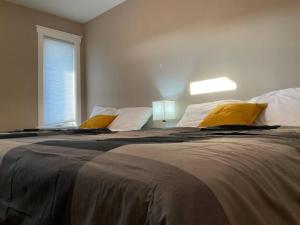 里贾纳NairaVilla: upscale accommodation for groups的一间卧室配有一张带黄色枕头的大床
