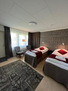 HammarstrandHotell Hammarstrand的酒店客房,配有两张床和椅子