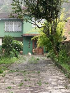 彼得罗波利斯Casa Verde em Petrópolis的站在房子前面的狗