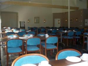 穆尔舍穆尔舍Vip酒店的一间摆放着桌子和蓝色椅子的房间