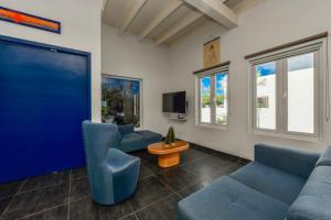 Santa CruzA Serene Retreat with Modern Amenities的客厅配有蓝色的沙发和平面电视。