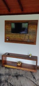 卡皮托利乌Pousada Jipe Canastra的墙上的电视机,木架