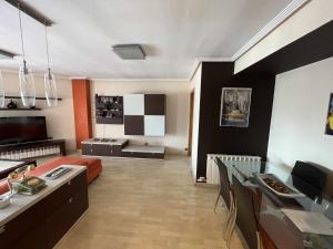 萨拉戈萨MuroHouse Apartamento con piscina Fibra1Gb Wifi Garaje的带沙发的客厅和用餐室