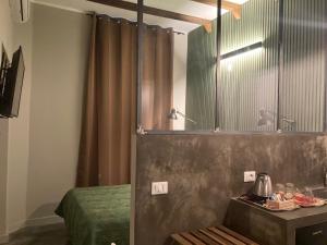 米兰卡吕普索酒店的一间带镜子、一张床和一张桌子的浴室