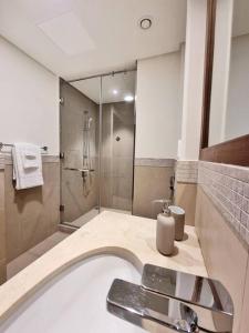 迪拜Spectacular Downtown Apartment T1-34的带淋浴和浴缸及水槽的浴室