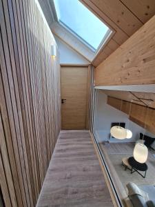 莫尔比耶Duplex type chalet dans le Jura的客房拥有木镶板墙和天窗。