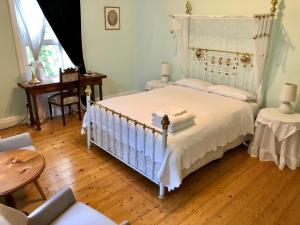 波特兰罗蕾莱住宿加早餐旅馆的卧室配有白色的床,铺有木地板