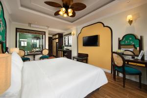 河内La Passion Hanoi Hotel & Apartment的卧室配有一张白色大床和一张书桌