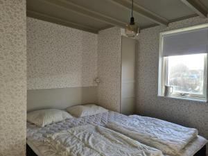 瓦尔贝里Minihuset nära havet的卧室内的一张床位,带窗户