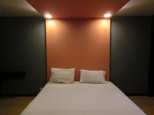 Ban KoNewYork Suite Hotel的一张带两个白色枕头的床