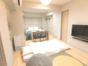 东京KLASSO Tokyo Sumiyoshi Apartments的一间客厅,内设一张床和一台电视机