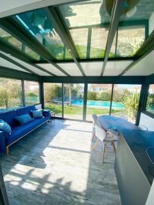 帕克斯港Magnifique maison avec piscine的一个带蓝色沙发和椅子的门廊