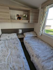 Sleeps 6 Modern and bright Caravan Littlesea Haven Weymouth客房内的一张或多张床位