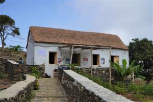 Ribeira GrandePousada Dragoeiro Monte Joana Santo Antão的白色的小房子,带有茅草屋顶