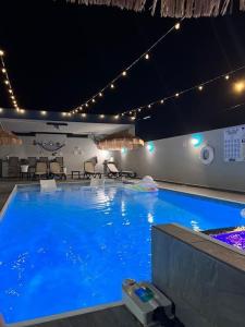 多拉多Aquaville Dorado Moderna Villa 5的夜间蓝色海水的大型游泳池