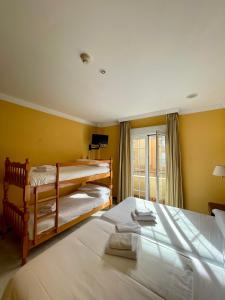 塞内斯德拉韦加HOTEL LA FONDA DE DON GONZALO的黄色墙壁客房的两张床