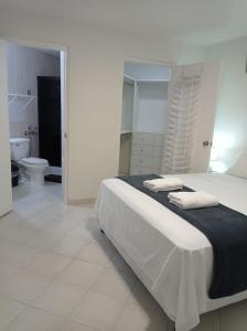 巴拿马城Doña Nancy的一间白色卧室,配有床和卫生间