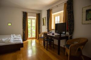 IllingenHotel Burg Kerpen的酒店客房设有一张桌子、一张床和一间卧室。