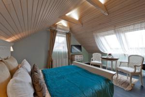 特拉凯维瓦塔卡尔酒店的一间卧室配有一张大床和一张桌子及椅子