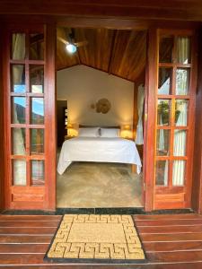 韦尔卡鲍Chalés Vila Do Vale的一间设有床铺的卧室,位于带窗户的房间内