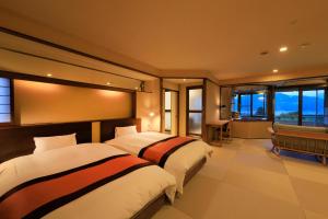 上山市叶山馆的带窗户的酒店客房内的两张床
