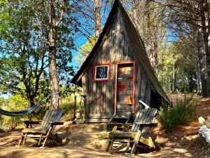 罗卡蒂德里Agriturismo Pereti的小屋前方设有2把椅子