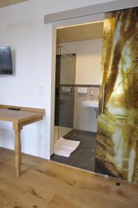 PinsdorfGasthaus Reiter的带淋浴的浴室和木桌