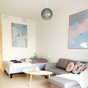 万塔New studio Pastel near Helsinki airport in Kivistö的客厅配有沙发和桌子