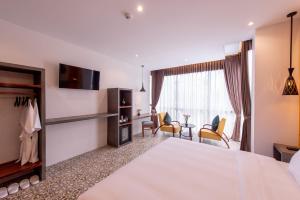 暹粒Siem Reap Palace Hotel & Spa的酒店客房设有一张大床和一间客厅。
