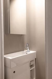 赫尔辛基2ndhomes Mikonkatu Apartment 4的浴室设有白色水槽和镜子