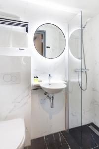 阿姆斯特丹Ciao Papa Hotel Amsterdam Central Station的白色的浴室设有水槽和镜子