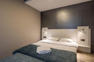 伊斯坦布尔Element Residence的一间卧室配有两张带白色床单的床