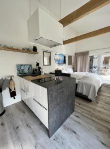 雷讷瑟Tussenrenesseenstrand的一间厨房,配有白色的橱柜和一张位于客房内的床