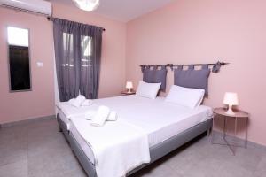 阿普索斯Casa Di Nina的一间卧室配有两张带白色床单的床