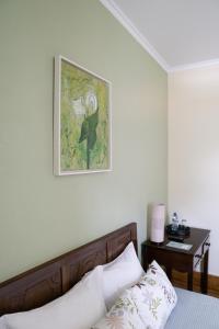 孔迪镇Casa Mindela Farmhouse的卧室配有一张床,墙上挂着一幅画