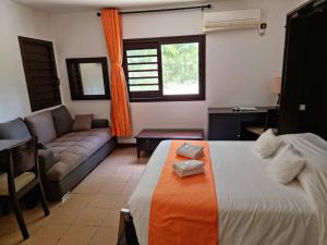 利富岛Hotel Oasis de Kiamu的客厅配有床和沙发