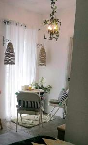 桑托斯将军城Dolores Residences Rm Bianca的客厅配有桌椅和吊灯。