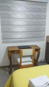 里奥加耶戈斯Vientos del Sur的一张木桌,在窗口前,配有一张桌子