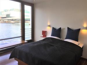 哥本哈根CPH生活酒店的一间卧室设有一张大床和大窗户