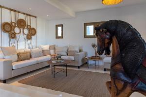安倍拉斯Amalgam Homes Paros的客厅配有沙发和马头雕像