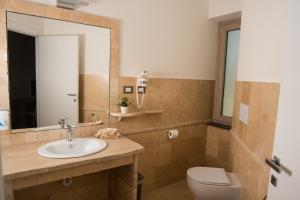 阿巴桑塔Regia Hotel的一间带水槽、卫生间和镜子的浴室