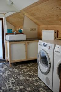 JodoigneGîte l'Ecurie的厨房配有洗衣机和水槽